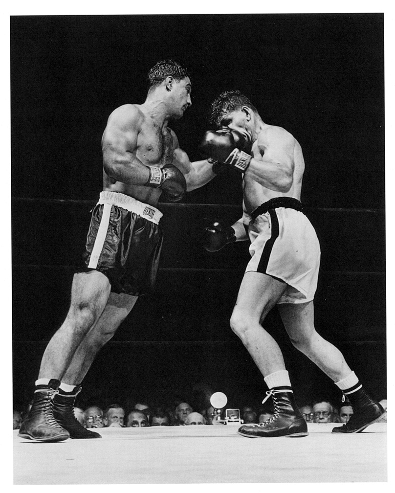 Rocky Marciano punches Rex Layne so hard Laynes mouthguard flies into the crowd along with his teeth