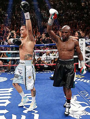 Both fighters signal victory after the fight